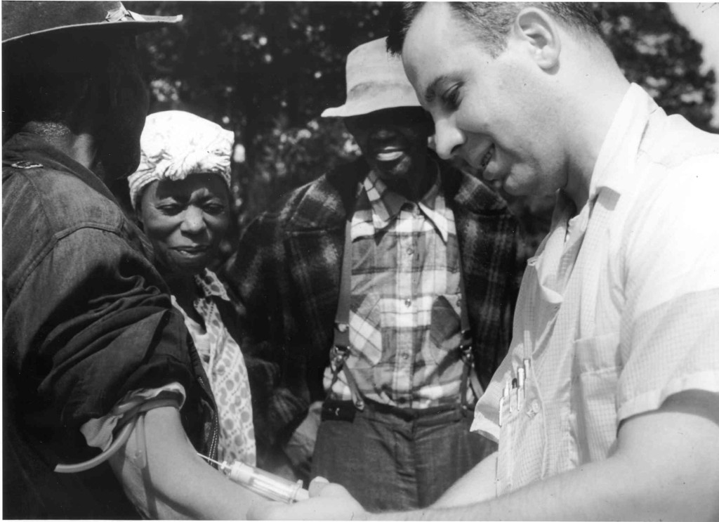 Unidentified subject, onlookers and Dr. Walter Edmondson taking a blood test (NARA, Atlanta, GA)